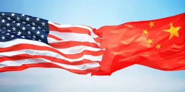 Two American and Chinese flags flying in the sky, symbolizing the progress made in US-China relations during Yellen's Beijing visit.