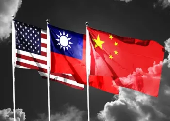 Three American and Chinese flags flying in the sky, symbolizing the high-stakes competition and collaboration between both nations.