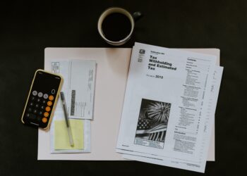 Irs forms and a cup of coffee on a desk, 2026.
