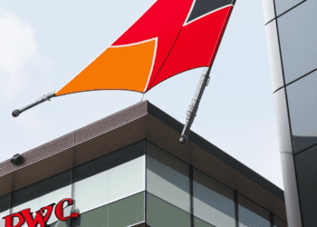 PwC flag flying outside of a building.