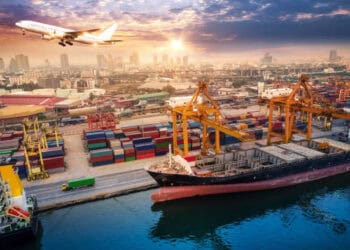 Cargo ship at the Port of Long Beach, with cranes and containers. December cargo volume increase. - Supply Chain News