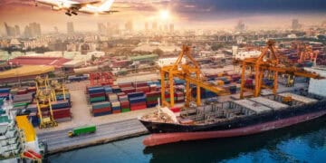 Cargo ship at the Port of Long Beach, with cranes and containers. December cargo volume increase. - Supply Chain News