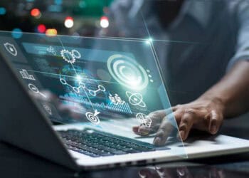 A person is using a laptop integrated with Anaplan software.