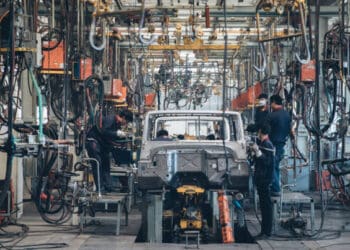 Workers assembling Chinese-made vehicles in a factory, amid discussions by US lawmakers to increase tariffs.