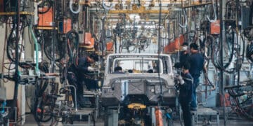 Workers assembling Chinese-made vehicles in a factory, amid discussions by US lawmakers to increase tariffs.