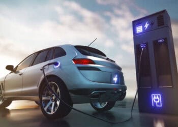 A Tesla car is plugged into a charging station in India to attract reduction in EV tariffs.