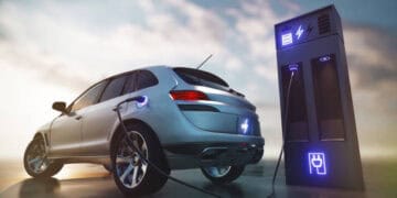 A Tesla car is plugged into a charging station in India to attract reduction in EV tariffs.