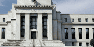 The building is white, and its surroundings echo the Federal Reserve's rate cut strategy.