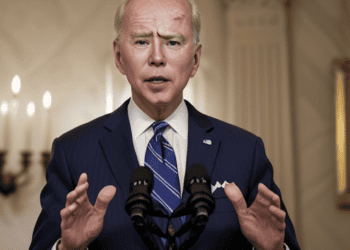 Joe Biden, the US President, is currently delivering a speech at a podium.