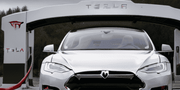 A Tesla Model S, manufactured by Elon Musk's Tesla, parked in front of a garage.