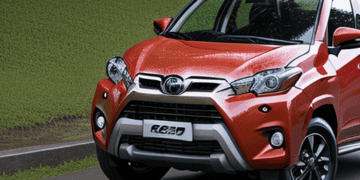 The Toyota Rush is driving down the road.