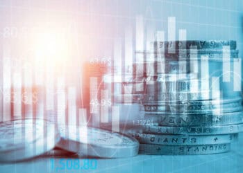 A stack of coins on a table with a blue background representing the economic impact of tariff concessions between Chinese Mainland and Taiwanese products.