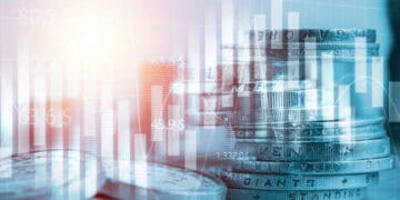 A stack of coins on a table with a blue background representing the economic impact of tariff concessions between Chinese Mainland and Taiwanese products.