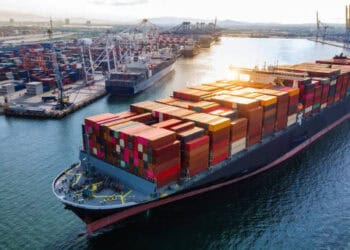 A large container ship docked in a port, enhancing shipping services for Dole's tropical fruits.