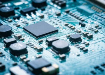 Close up of electronic components on a circuit board, showcasing surplus semiconductors.