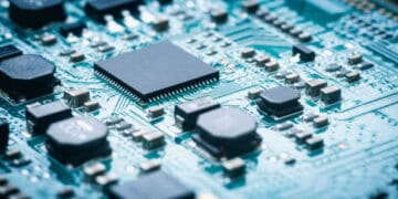 Close up of electronic components on a circuit board, showcasing surplus semiconductors.