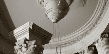 A clock mounted on a column in a building, creating mounting concerns.