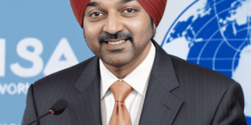 Ajay Banga, the elected President, confidently stands at the podium wearing a suit and turban.