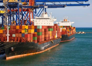 An ocean container ship docked at a port amidst increased Red Sea disruptions.