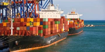 An ocean container ship docked at a port amidst increased Red Sea disruptions.