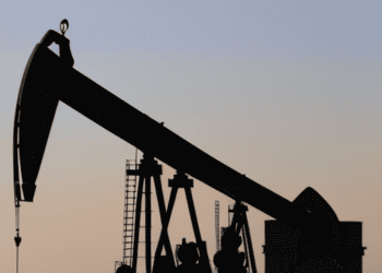 A silhouette of an oil pump in the desert, symbolizing Saudi Arabia's impact on the physical market.