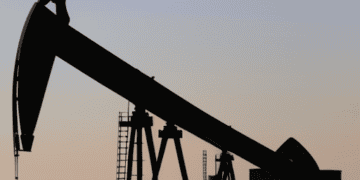 A silhouette of an oil pump in the desert, symbolizing Saudi Arabia's impact on the physical market.