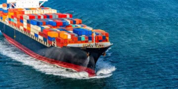 A massive container ship navigating the ocean, connecting global retailers amidst the Red Sea Conflict.