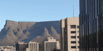 A cityscape with a majestic mountain as the backdrop in South Africa.