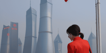 A woman wearing a red jacket, showcasing a global impact.