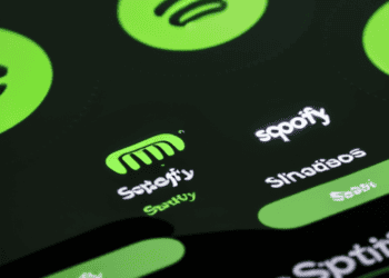 The Spotify logo is displayed on a cell phone, representing the popular streaming platform with 500 million active users.