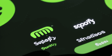 The Spotify logo is displayed on a cell phone, representing the popular streaming platform with 500 million active users.
