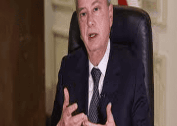 Riad Salameh, Lebanon's Central Bank Governor, sitting at a desk in a suit and tie.