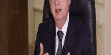 Riad Salameh, Lebanon's Central Bank Governor, sitting at a desk in a suit and tie.