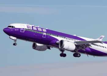 An airline facing operational challenges, despite bankruptcy, with a purple and white airplane flying in the sky.