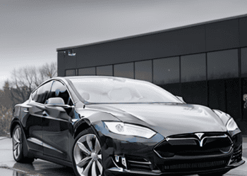 A black Tesla Model S with price cuts.