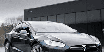 A black Tesla Model S with price cuts.