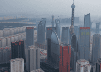 Aerial view of Shanghai skyline, showcasing modern skyscrapers and the Oriental Pearl Tower. Concerns about China's economic landscape, including deflation and consumer confidence, are reflected in the image's depiction of the city. - Supply Chain News