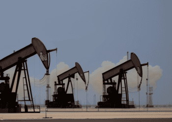 A group of oil rigs in a desert, serving as the backbone of the oil industry amidst fluctuating oil prices and increasing demand from China.