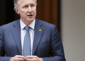 A man in a suit and tie standing in front of a building, representing the Australian Government's $10 billion response to cost of living pressures.