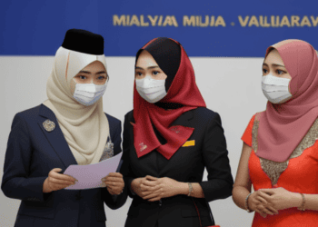 Three women in masks standing next to each other, emphasizing the importance of Malaysia's Reforms and the MM2H Visa Program.
