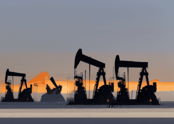Oil pumps in the desert at sunset, depicting Middle East oil production.
