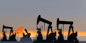 Oil pumps in the desert at sunset, depicting Middle East oil production.