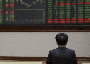Man views China stock market data showing decline; new regulations implemented. - Supply Chain News