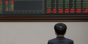 Man views China stock market data showing decline; new regulations implemented. - Supply Chain News