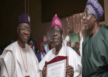 President-Elect Tinubu, along with two other men, is holding a certificate, addressing a crowd of Nigerians about recent economic reforms.