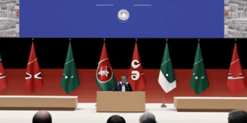 A group of G7 men at a podium with flags in front of them, discussing international norms and economic coercion.