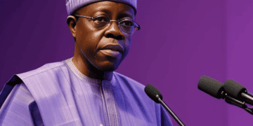 The President of Nigeria, wearing a purple shirt, is giving a speech on economic revitalization.