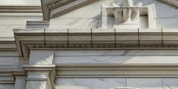 A white building with a flag on top, representing the US Federal Reserve.