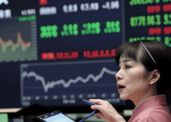 A woman holding a pen and a tablet reflects on Asia Stocks.