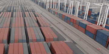 A container ship docked at a port in South Korea.